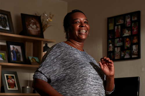 Smiling black woman doing exercise at home