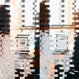 two people looking at computer, shot from behind