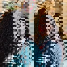 two women talking outside a shop