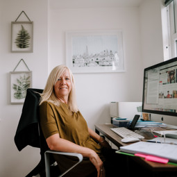 Woman in home office smiling