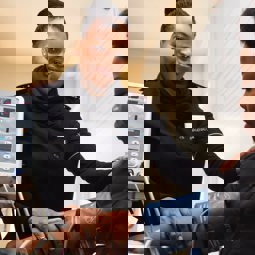 woman using blood pressure machine on patient