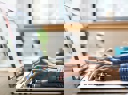 man typing on a laptop